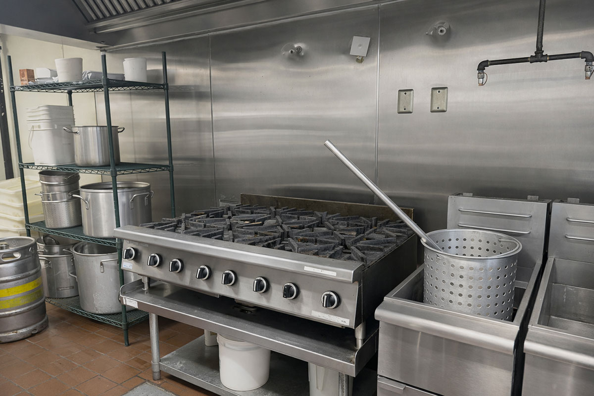 Restaurant Cooking Line & Equipment | Cedar Park TX Commercial Property Commercial restaurant cooking line with gas range and fryer in Cedar Park Texas on RM 620 corridor